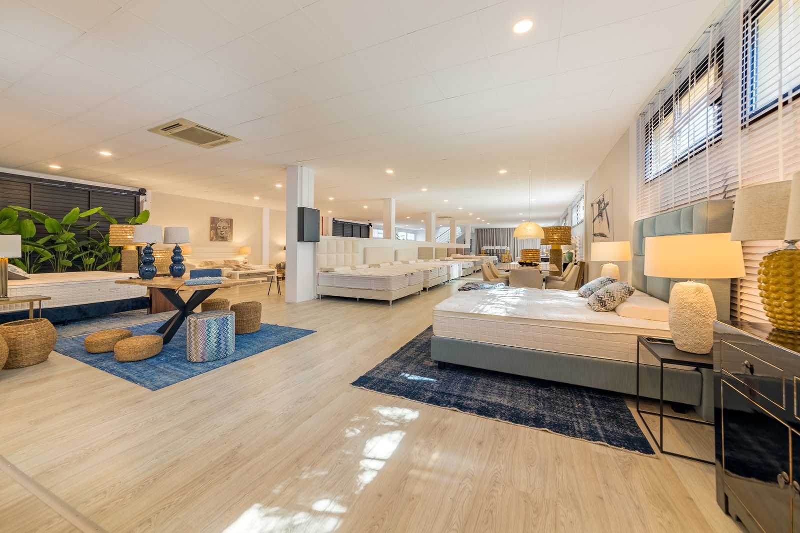 COCOON Mallorca – Wohnbereich mit Bett, Teppich und Sitzgruppe